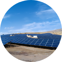 Solar panels installed on a hillside under a clear blue sky.