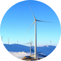 Wind turbines standing tall in a snowy landscape.