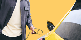 Driver plugging in an illustrated electric car charger into their yellow car