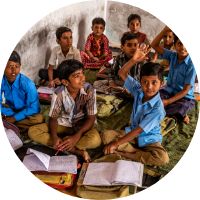 A group of children reading textbooks.