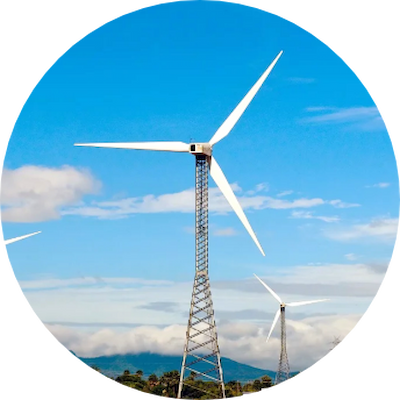 Wind turbines stand tall against a clear blue sky.